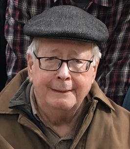 Older gentleman with a gentle smile wearing a hat
