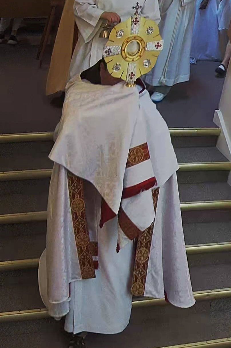 Monstrance being carried by Priest wearing gold veil