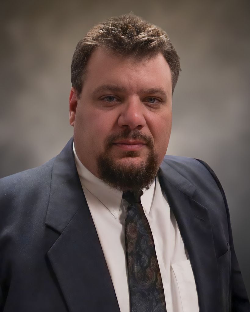 Smiling man with facial hair