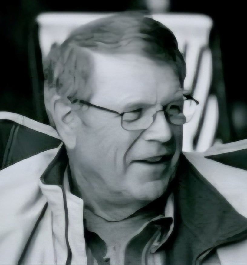 Black and white photo of a man wearing glasses
