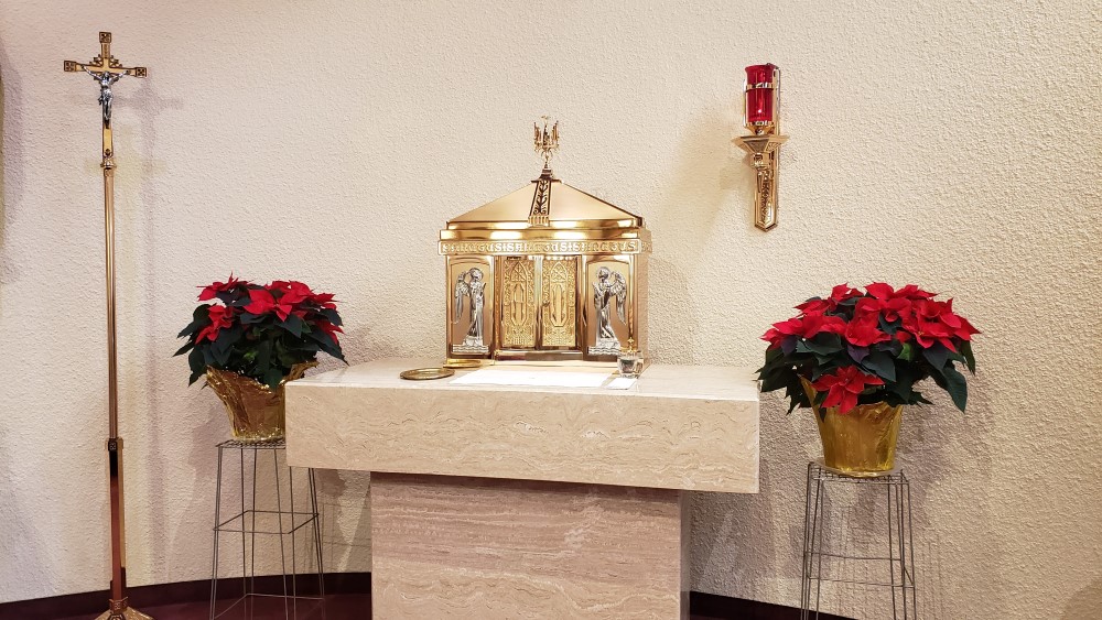 Gold Tabernacle, Box where Christ is housed, surrounded by red poinsettias