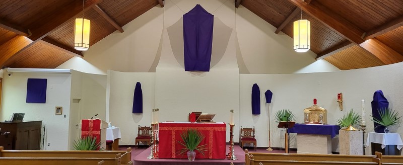 cropped view of the sanctuary, red linens and purple cloth on cross