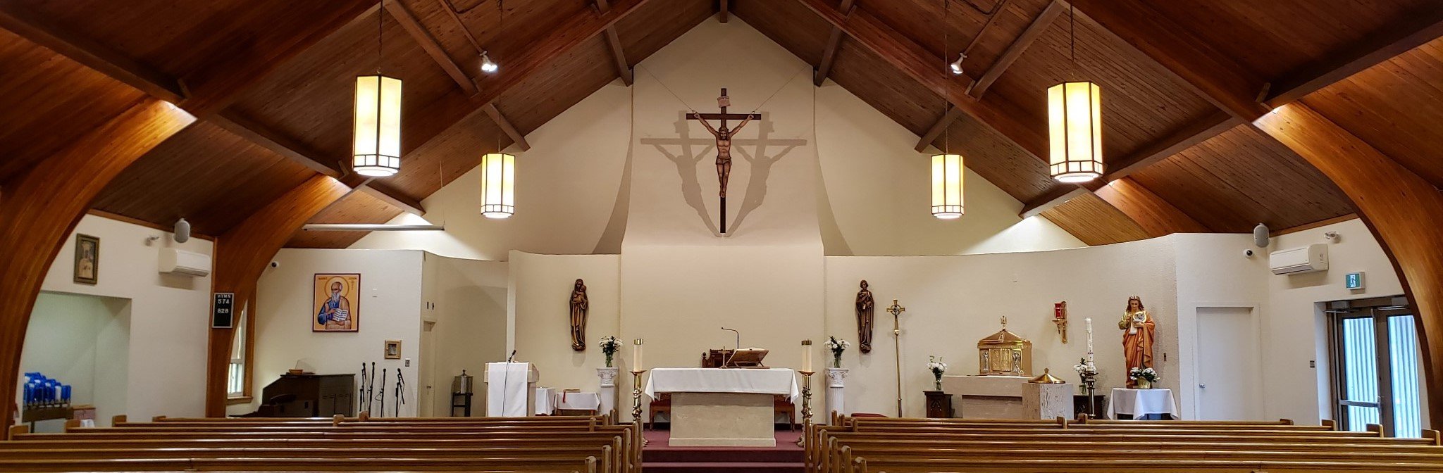 An inside view of the Sanctuary of St. John the Evangelist Parish, Weston.  Wide panoramic view from the candleside to the side doors of sanctuary.