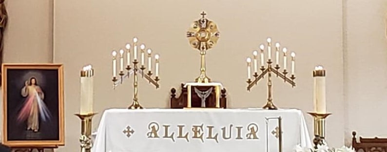 Church during Holy hour, Crucifix with white cloth, Monstrance with Blessed Sacrament, Divine mercy image