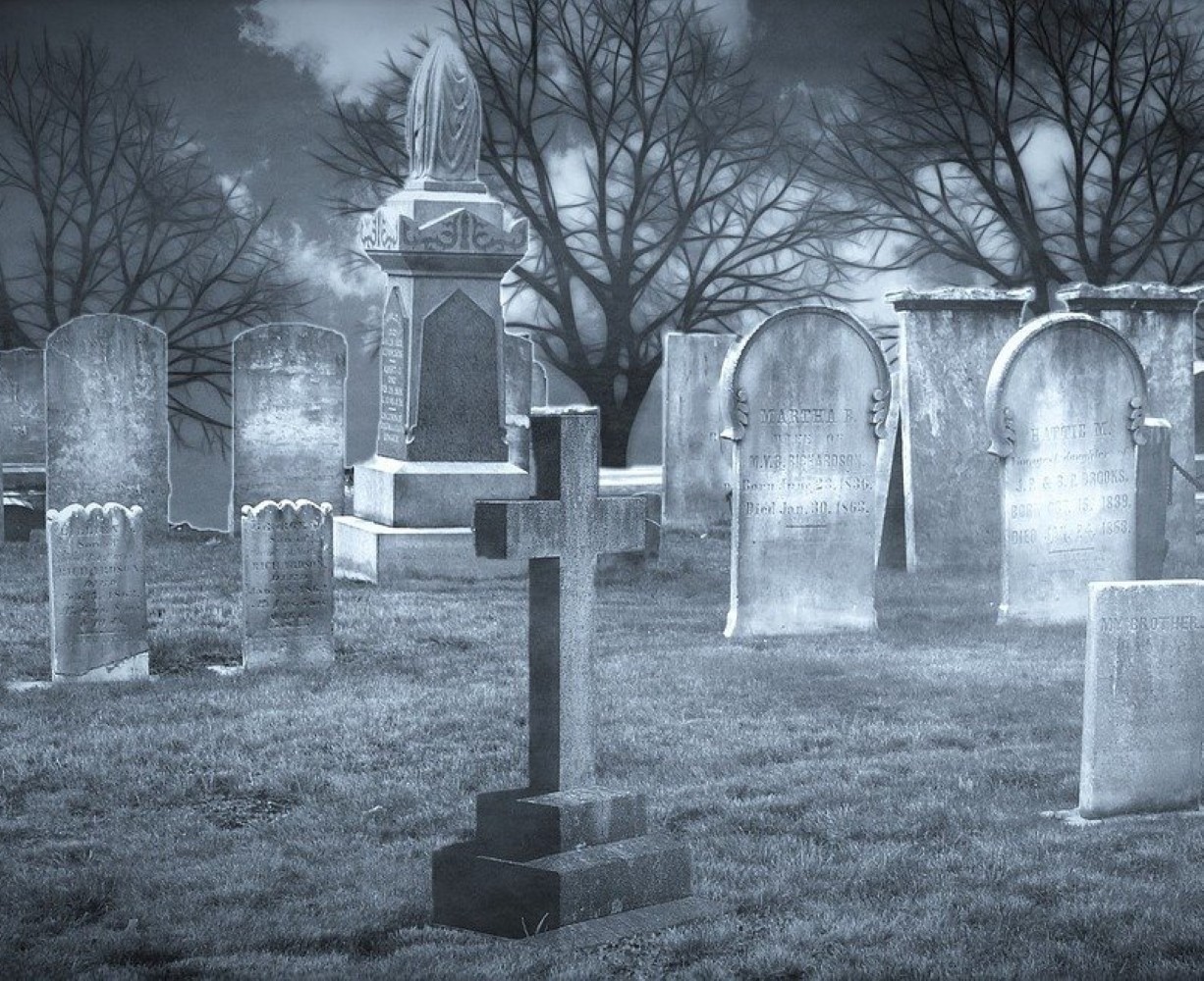 A black and white picture of an older cemetery