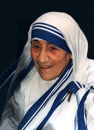 St. Teresa in her white and blue habit with a large smile