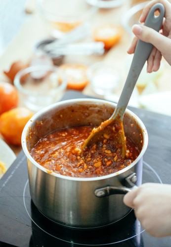 Preparing a steaming hot chili in a sauce pan in